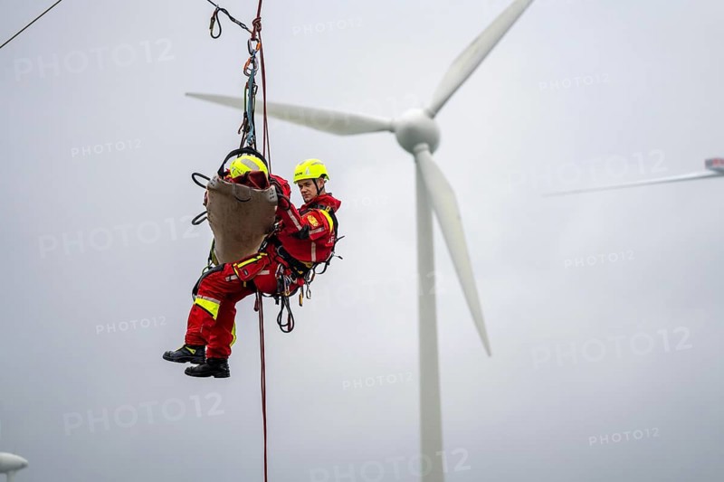 Height rescuers from the Oberhausen professional fire brigade practise abseiling from a wind turbine from a height of 150 metres, rescuing an injured person, technician, from the nacelle, Issum, North Rhine-Westphalia, Germany, Europe