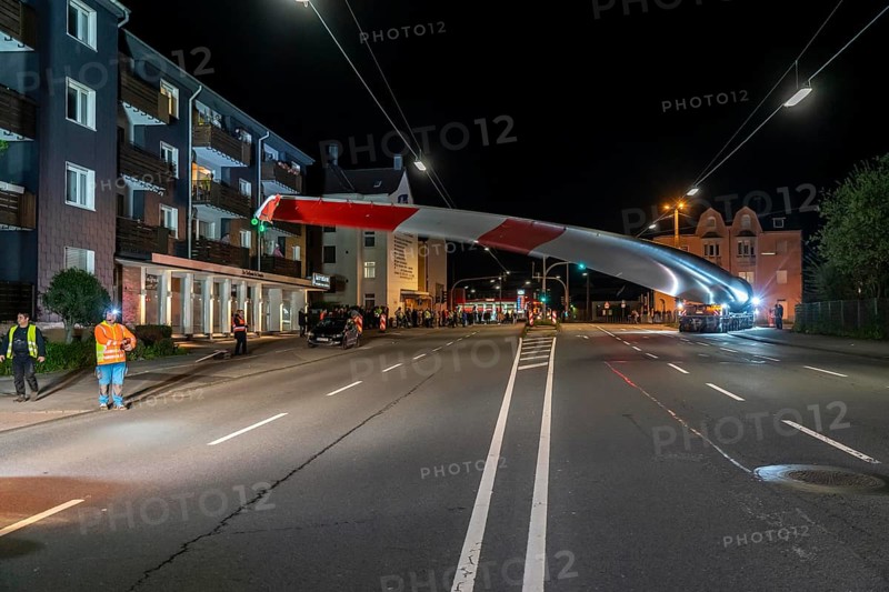 Transport of a 68 metre long, 22 tonne blade of a wind turbine, here in Schwelm, with a self-propelled Blade-Lifter vehicle, over a 40 km long route, over 2 nights, in the Bergisches Land, through towns, villages, over country roads, narrow through roads, to the construction site of the wind turbine near Hagen, North Rhine-Westphalia, Germany, Europe