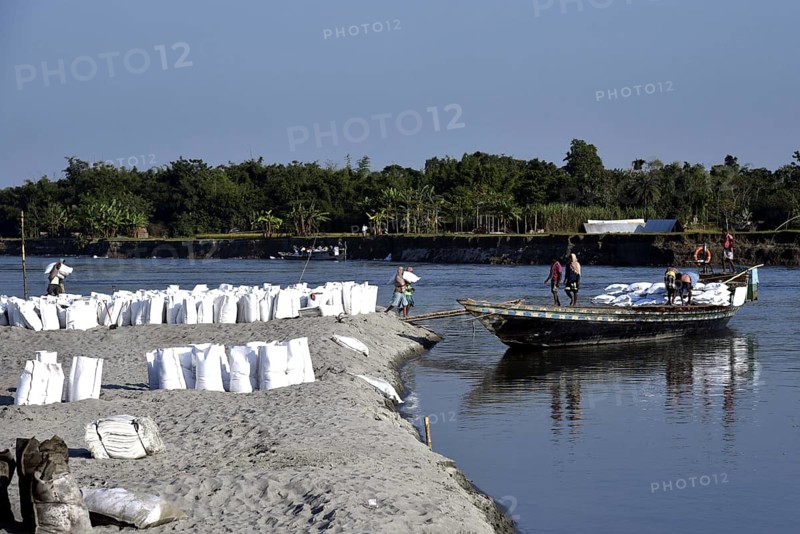 Public Works Department (PWD) of Assam labourer carrying sand bag to boat in Beki River to make sand bag wall to reduce soil erosion in Barpeta, Assam in India on Tuesday, November 13, 2018. The soil erosion of Beki river has become a major problem of flowing two districts Barpeta and Baksa of Assam