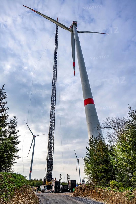 Erection of a wind turbine, wind energy plant, assembly of the third blade, with a crawler lattice crane, wind farm near Hagen, North Rhine-Westphalia, Germany, Europe