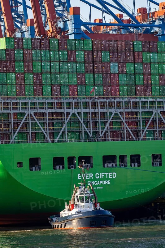 Container ship Ever Gifted, arriving at the port of Hamburg, Waltershofer Hafen, HHLA Container Terminal Burchardkai, 4 harbour tugs manoeuvre the ship to the quay, shipping company Evergreen, Singapore, 399 m long, can transport over 20, 000 containers, Hamburg, Germany, Asia