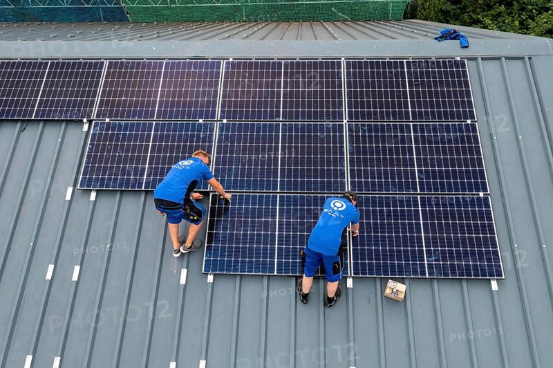 Installation of solar modules on the roof of a barn on a farm, over 240 photovoltaic modules are installed on the roof, North Rhine-Westphalia, Germany, Europe
