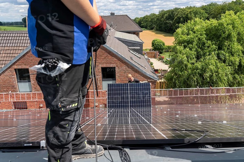 Installation of solar modules on the roof of a barn on a farm, over 210 photovoltaic modules are installed on the roof, North Rhine-Westphalia, Germany, Europe