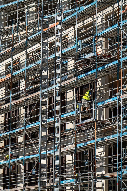 Construction site, at the Cologne Trade Fair Centre, new construction of a high-rise office building, construction cranes, facade of the shell, scaffolding, North Rhine-Westphalia, Germany, Europe
