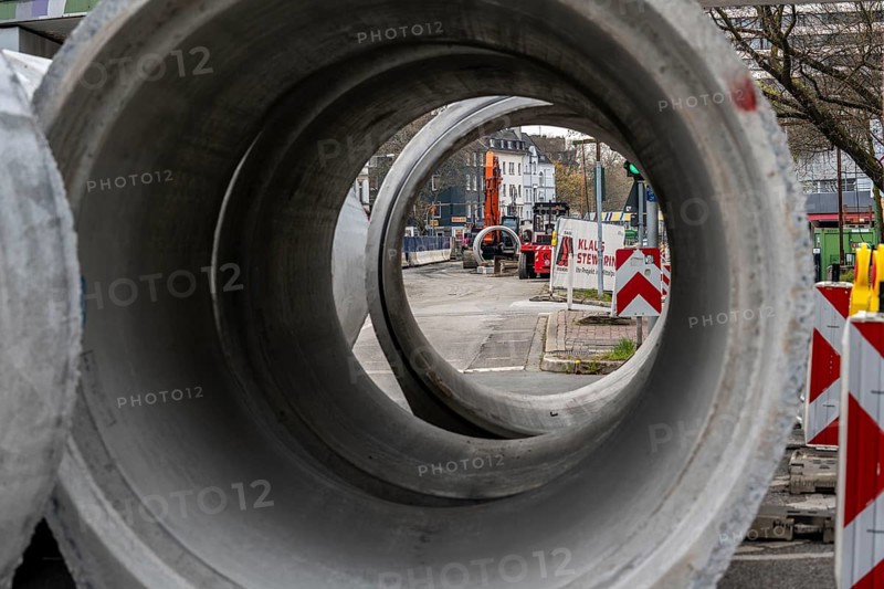 Concrete sewer pipes, stored on a construction site during sewer renovation work, on the Dickswall, city centre of Mülheim an der Ruhr, North Rhine-Westphalia, Germany, Europe