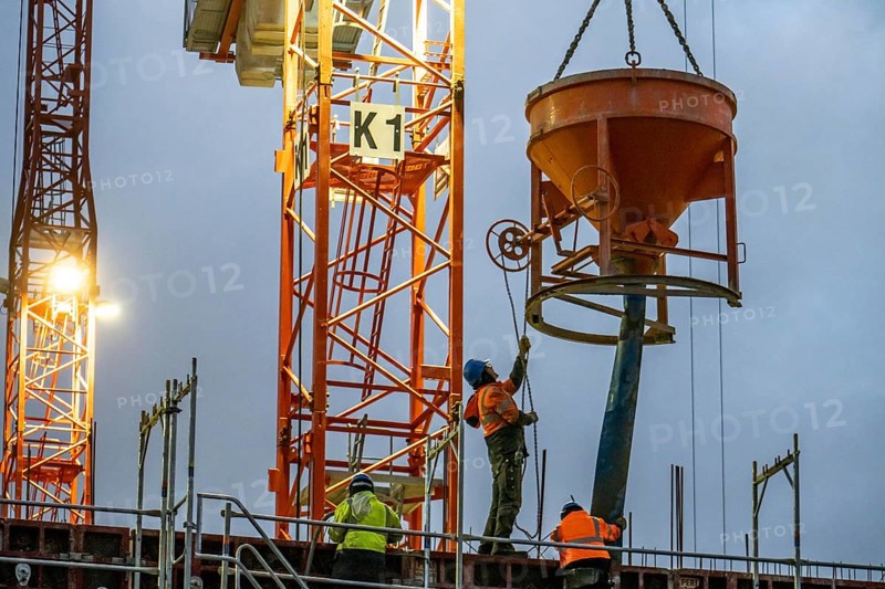 Concrete work, at dusk, on a large construction site building a residential and commercial complex, North Rhine-Westphalia, Germany, Europe