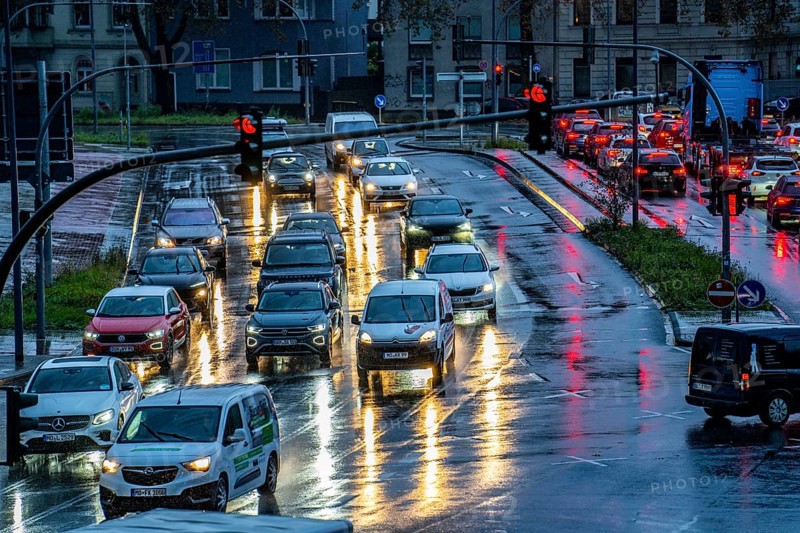 Rainy weather, road traffic, intersection, lights of vehicles on a wet road, traffic lights, tail lights, headlights, symbolic image