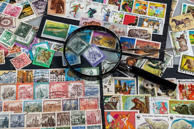 Stamp collection, collect, postage stamps, postage stamps from different countries, magnifying glass