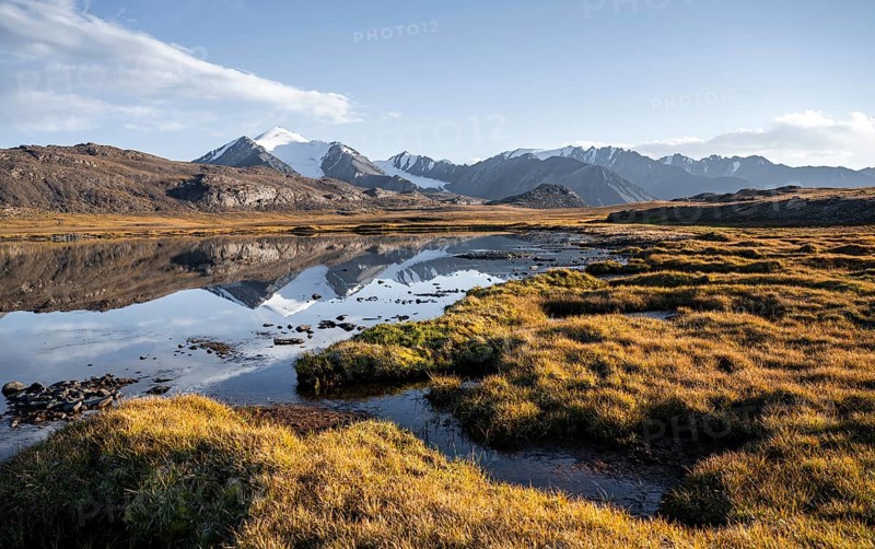 Glaciated mountain peaks reflected in a mountain lake at sunset, Arabel Lake at Arabel Pass, Issyk Kul Province, Kyrgyzstan, Asia