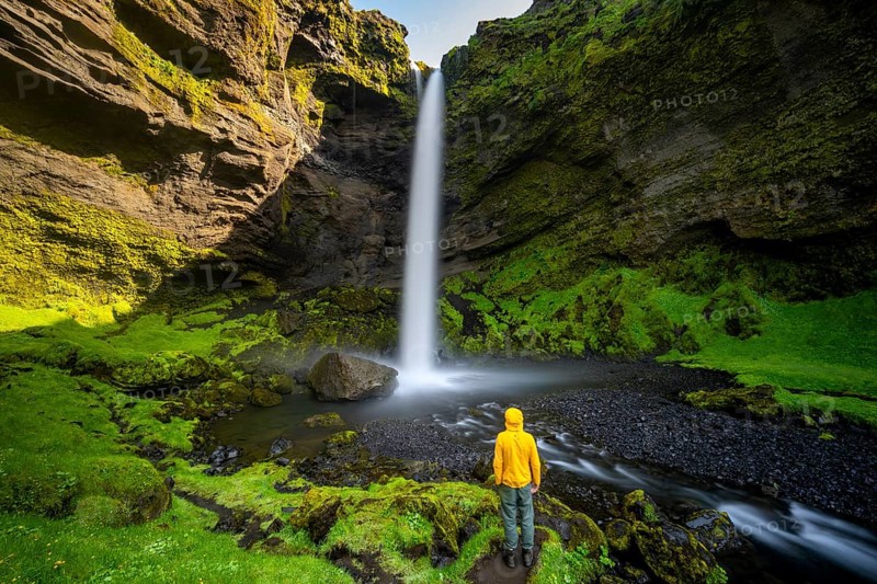 Tourist at Kvernufoss waterfall, in summer when the weather is nice, gorge and river, long exposure, Skogar, Sudurland, South Iceland, Iceland, Europe
