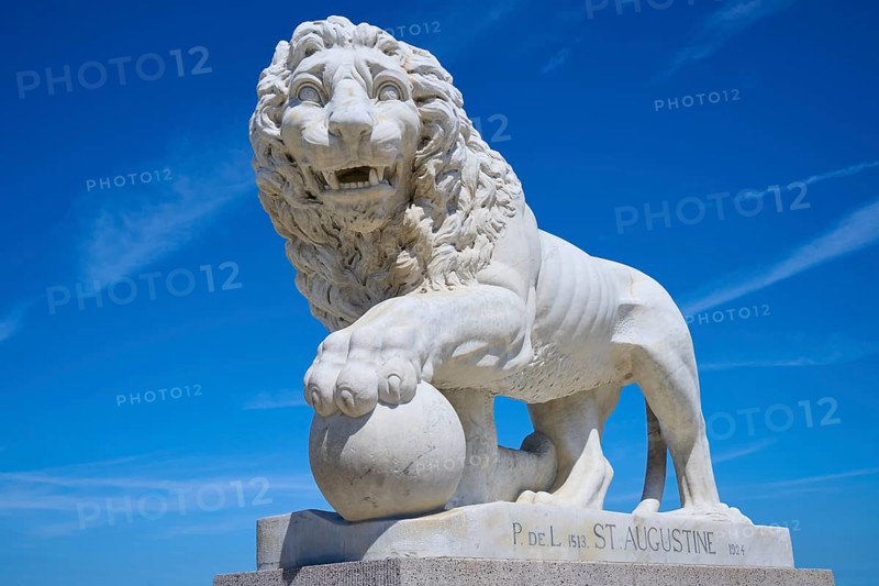 An impressive lion statue on a pedestal, on the Bridge of Lions, St Augustine, harbour, Matanzas River, Florida, USA, North America