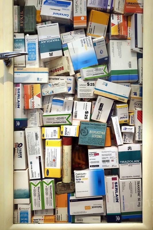 Medicine cabinet filled with medication boxes, drugs for treating mental diseases