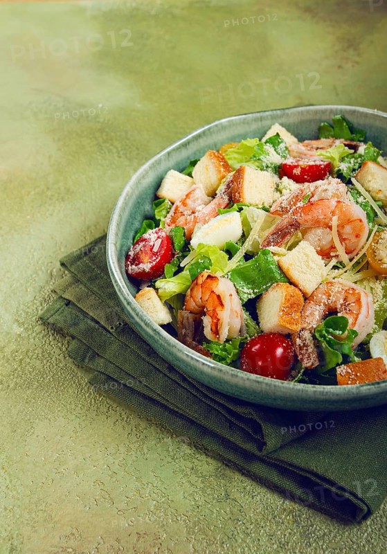 Caesar salad, with tiger prawns, shrimp salad, lettuce, quail eggs, cherry tomatoes, parmesan cheese, no people