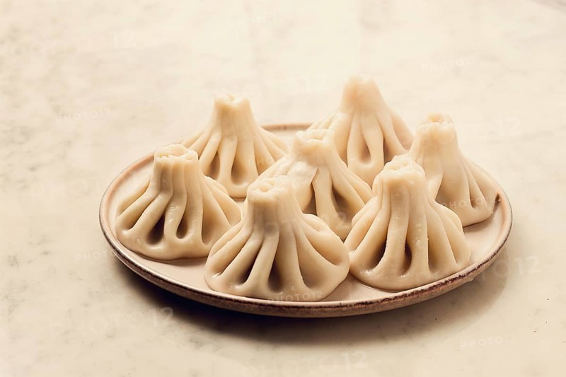 Traditional Georgian dish, Khinkali Kalakuri, on a marble table, selective focus, rustic, toned photo, horizontal, no people