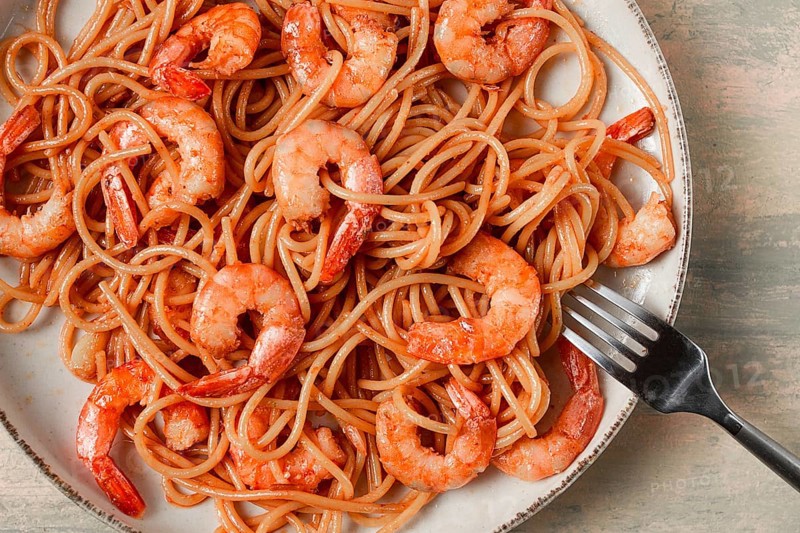 Spaghetti with king shrimps, with spices, top view, selective focus, homemade, no people