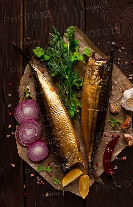 Smoked mackerel, top view, with spices, on a wooden table, no people, selective focus