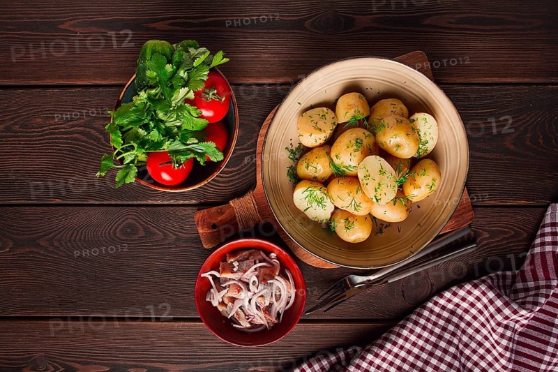 Fresh Cooked, new potatoes, with dill, on a wooden table, selective focus. close-up, toning, no people