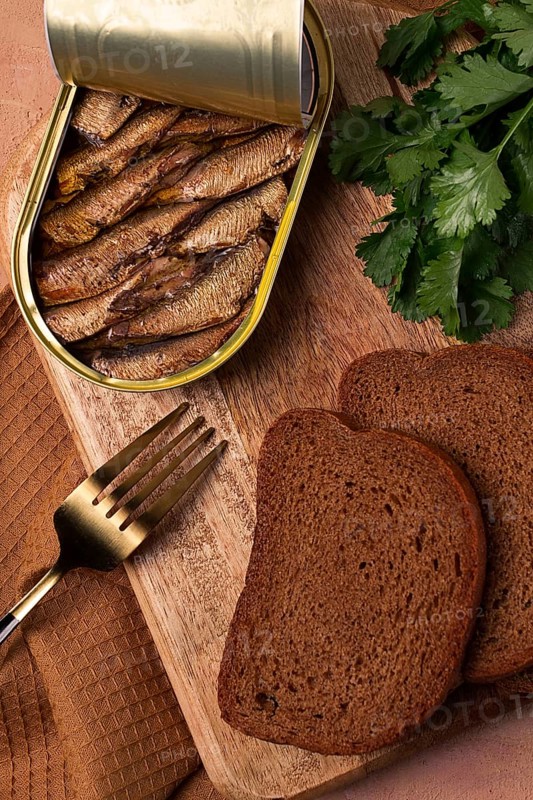 Preserves, sprats with black bread, top view, no people