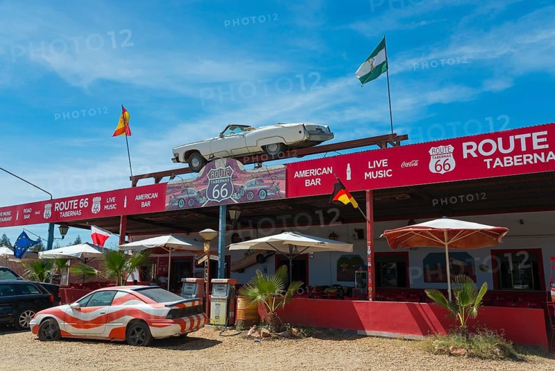 A Route 66-style retro taberna with flags, cars and parasols under a blue sky, Tabernas Desert, Desierto de Tabernas, Tabernas, Almeria, Andalusia, Spain, Europe