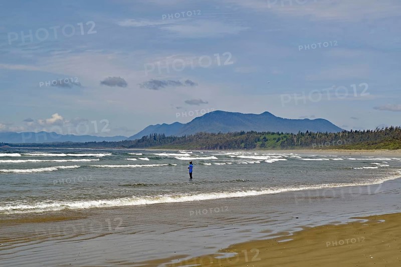 Endless empty sandy beach with swell and mountains in the background, Long Beach, Pacific Rim National Park, Vancouver Island, British Columbia