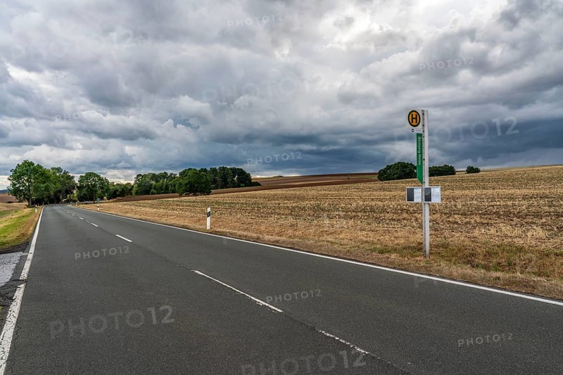 Single stop of bus line 510 between Korbach and Bad Wildungen, country road near Waldeck in North Hesse, bus stop Abzweig Netze, bus traffic between 6 a.m. and 5 p.m., NVV, Nordhessische VerkehrsVerbund, thunderstorm front approaching, Germany, Europe