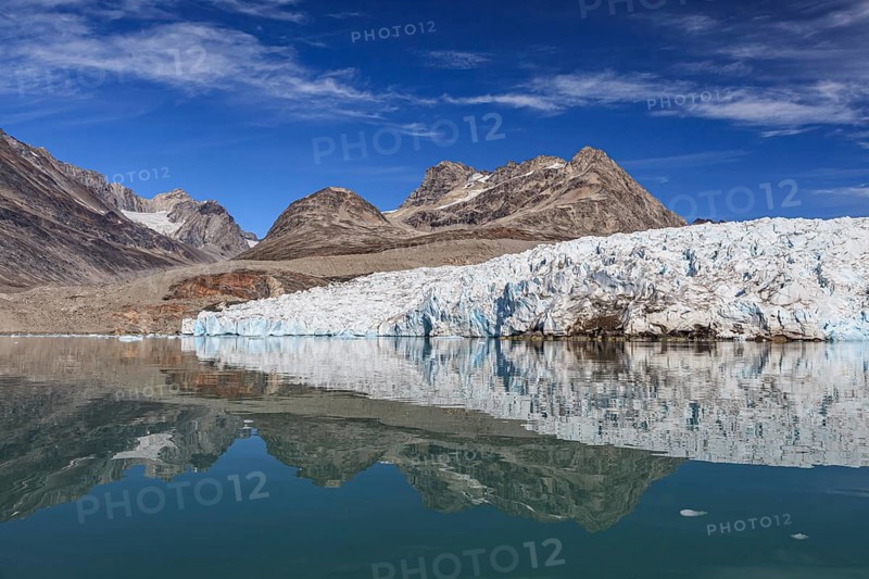 Glaciers and mountains reflected in fjord, sunny, East Greenland, Greenland, North America
