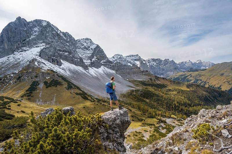 Mountaineer enjoying the view, mountain panorama with rocky steep peaks, view of summit Lamsenspitze, Dreizinkenspitze and Spritzkarspitze, hike to the summit of Hahnkampl, Engtal, Karwendel, Tyrol, Austria, Europe