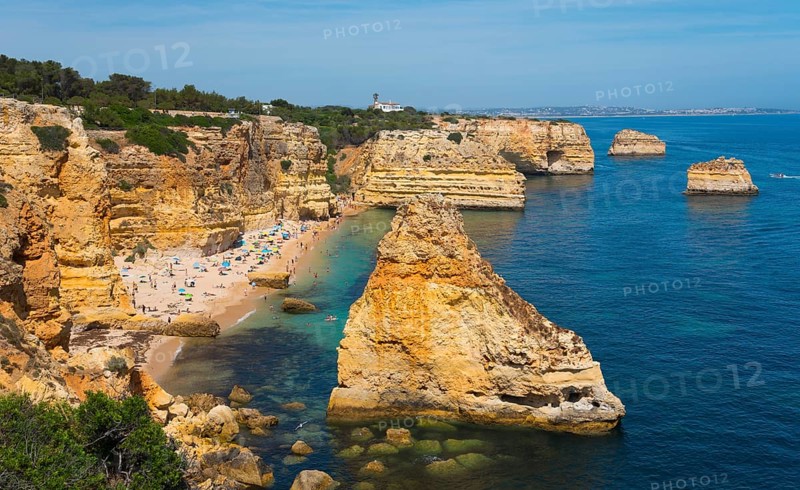 Coastal landscape with rocky cliffs and a beach on the clear blue ocean under a sunny sky, Praia da Marinha, Lagoa, Rocky Algarve, Algarve, Portugal, Europe