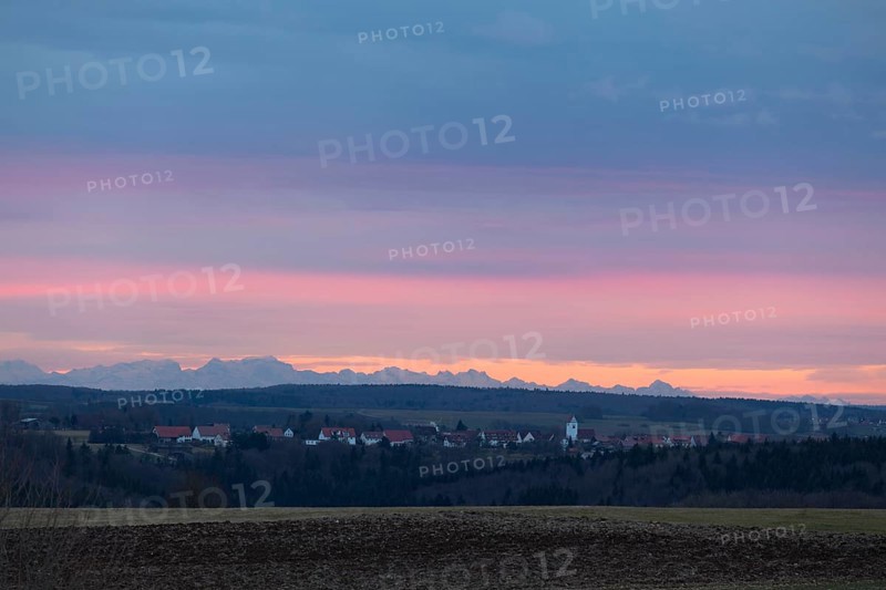 Alpine panorama near Magolsheim. Säntis, Swiss Alps at sunset with a view of Mehrstetten. View from the Alpenblick tower