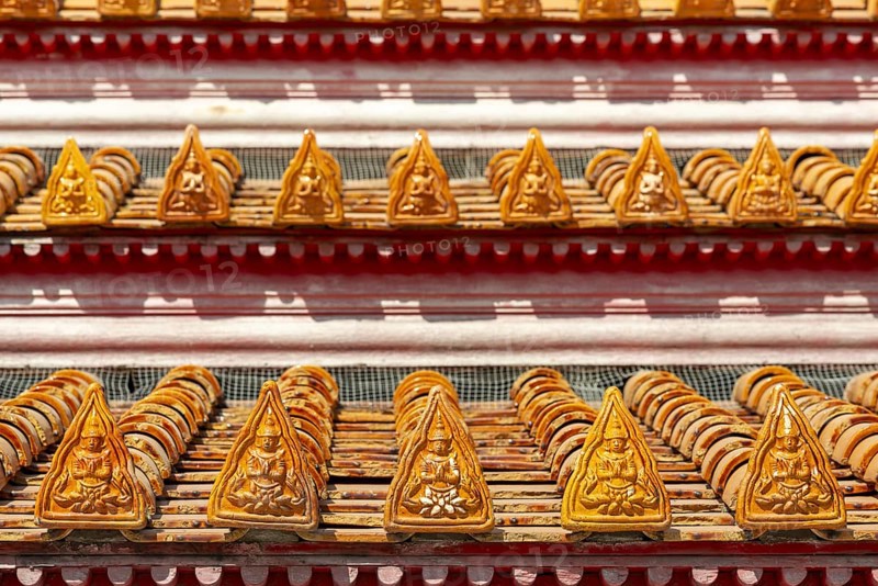 Roof decoration at the Uposatha Hall, Ubosot, the roof is staggered in three tiers and covered with rows of golden yellow glazed Chinese tiles, the last tile of each row at the eaves represents a heavenly angel offering the traditional Thai obeisance Wai to the viewer with folded hands, Wat Benchamabophit, marble temple, Bangkok, Thailand, Asia