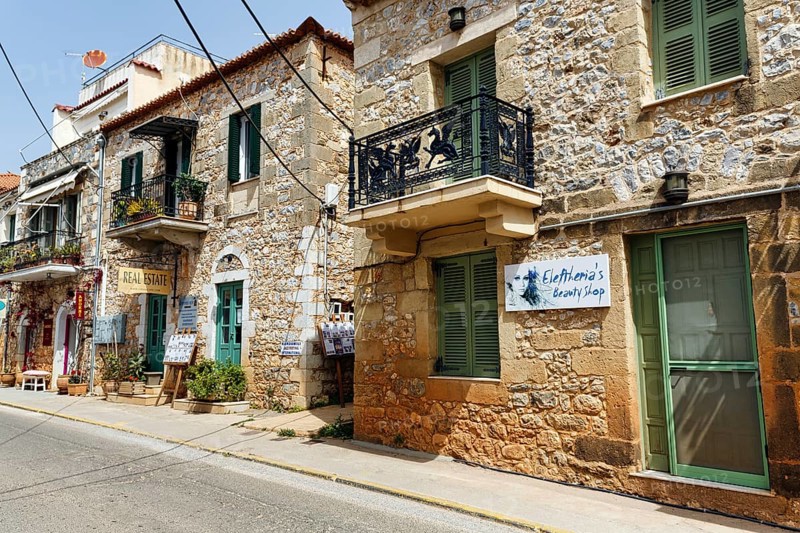 Typical stone houses with shops, souvenir shops, Stoupa, former fishing village, Mani, Greece, Europe