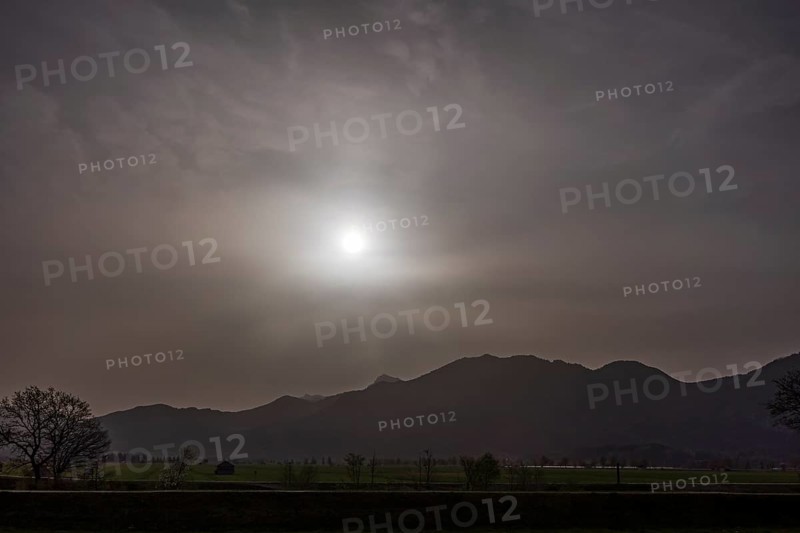 Sahara dust covers the sun in front of a mountain landscape, spring, Loisach-Lake Kochel-Moore, Bavaria, Germany, Europe