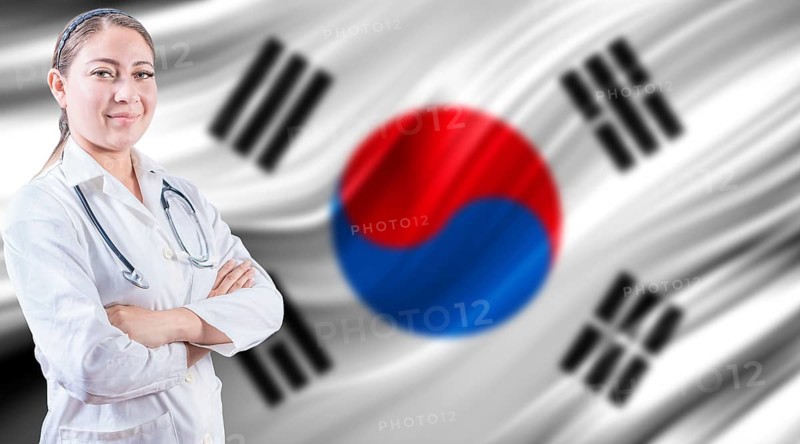 Doctor with crossed arms on South Korean flag. Doctor with stethoscope on South Korean flag. Medical health and care on South Korean flag