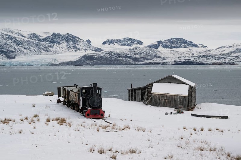 Historic mine railway in front of the wintery, snow-covered Kongsfjorden, Ny-Ålesund, Spitsbergen Island, Svalbard and Jan Mayen archipelago, Norway, Europe