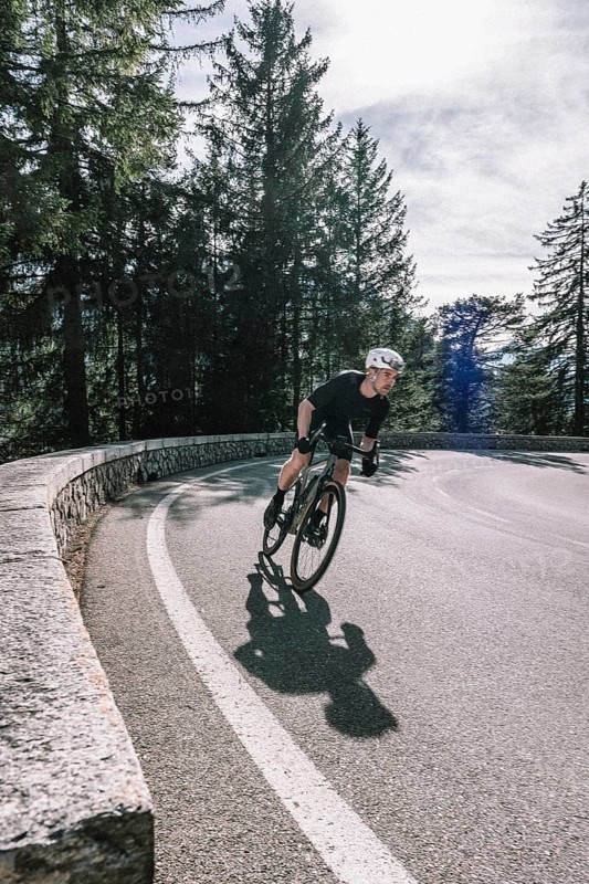 Road bike rider in spring between Lechtal and Tannheimer Tal in front of picturesque scenery of the Alps, Tyrol, Austria, Europe