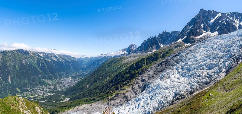 Panorama, mountain landscape with glacier Glacier des Bossons and summit of the Aiguille du Midi, view into the valley with the village of Chamonix, Chamonix, Haute-Savoie, France, Europe