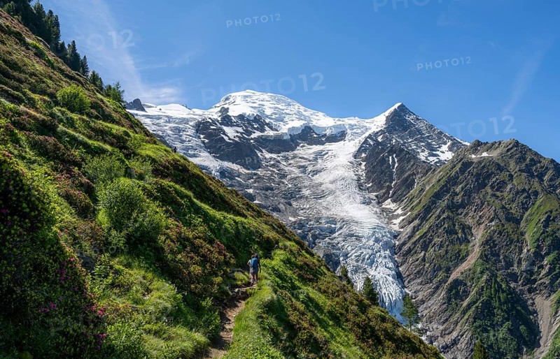 Hiker on hiking trail La Jonction, mountain landscape, view of glacier Glacier de Taconnaz, Chamonix, Haute-Savoie, France, Europe