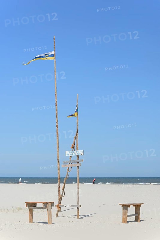 Pile dwelling on the extensive sandy beach, wooden piles with Juist flag, wooden planks with inscriptions, wooden benches, blue sky, North Sea, Juist, East Frisian Islands, Lower Saxony, Germany, Europe