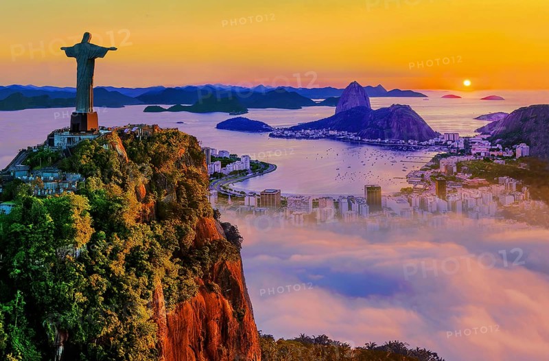Corcovado 710m with Christ the Redeemer statue above Botafogo Bay with Sugar Loaf 396m at sunrise and morning fog, Rio de Janeiro, Brazil, South America