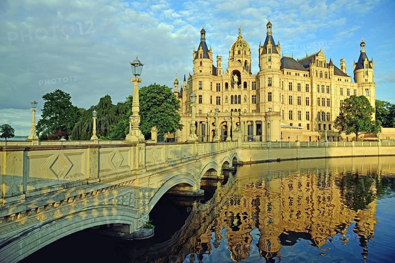 Europe, Germany, Mecklenburg-Western Pomerania, Schwerin, Schwerin Castle, built 1845 to 1857 in the style of romantic historicism, today seat of the state parliament, front with bridge to the castle island, evening light, Schwerin, Mecklenburg-Western Pomerania, Germany, Europe