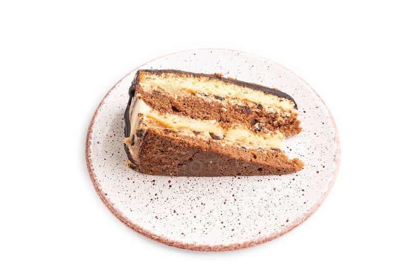 Chocolate biscuit cake with caramel cream isolated on white background. side view