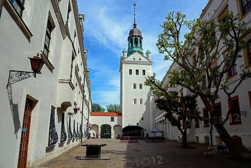 A sunny street leads to a historic building with a distinctive tower under a blue sky with clouds, courtyard of the Castle of the Dukes of Pomerania, Zamek Ksiazat Pomorskich, Old Town, Szczecin, Szczecin, West Pomerania, Poland, Europe
