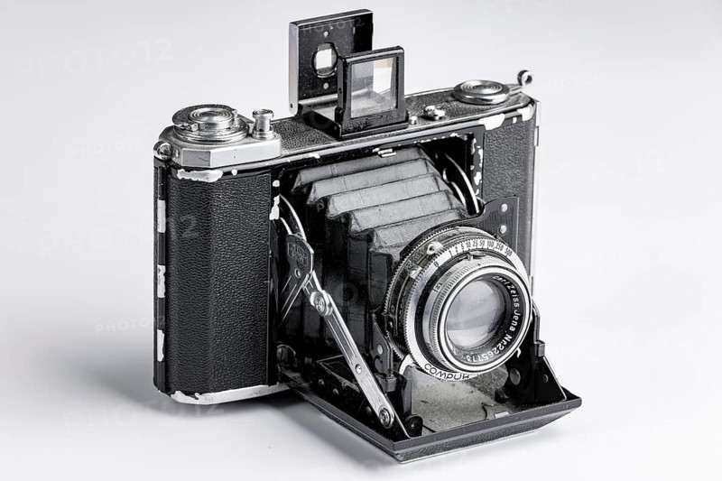 Old bellows camera with extended bellows and opened optical viewfinder