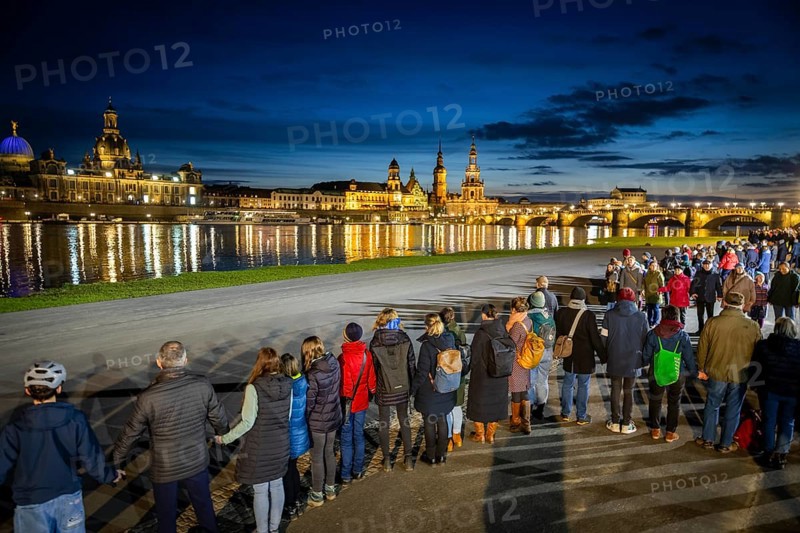 On 13 and 14 February 1945, Dresden was heavily destroyed in three Allied bombing raids. Every year, the people of Dresden commemorate this event at various events. A long human chain symbolised the protection of the city centre. Here looking from the Königsufer across the Elbe to the Old Town, Dresden, Saxony, Germany, Europe
