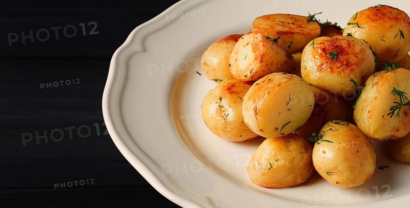 Fresh Cooked, new potatoes, with dill, on a wooden table, selective focus. close-up, toning, no people