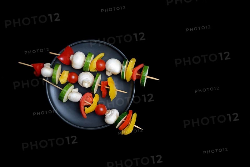 Colourful vegetable skewers on a plate, barbecue skewers