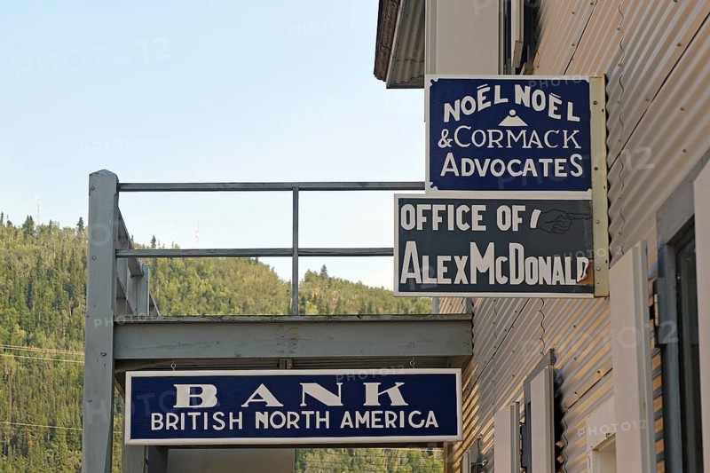 Historic signs advertising bank and lawyer, gold rush, gold mining town, Dawson City, Yukon Territory, Canada, North America