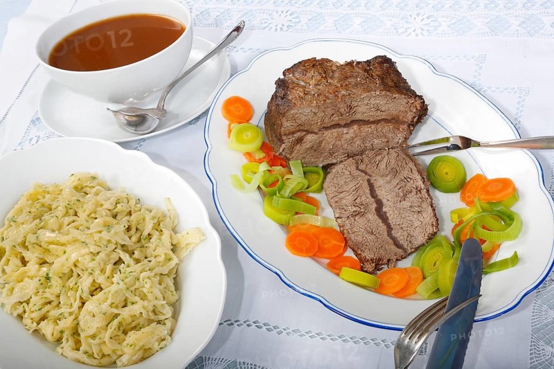 Swabian cuisine, roast beef, roast ox, herb spaetzle, meat dish, gravy, carrot vegetables, leek, serving platters, hearty, savoury, typical Swabian, home cooking, traditional cuisine, food photography, studio, Germany, Europe
