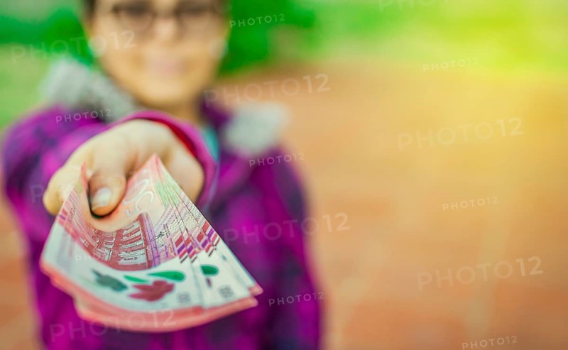 Young woman showing nicaraguan banknotes. Nicaraguan 500 cordobas banknotes