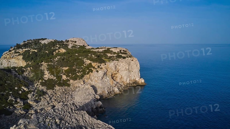 Drone shot, A rocky coastline with steep cliffs, calm sea and a clear blue sky, Anthony Quinn Bay, Vagies Bay, Rhodes, Dodecanese, Greek Islands, Greece, Europe